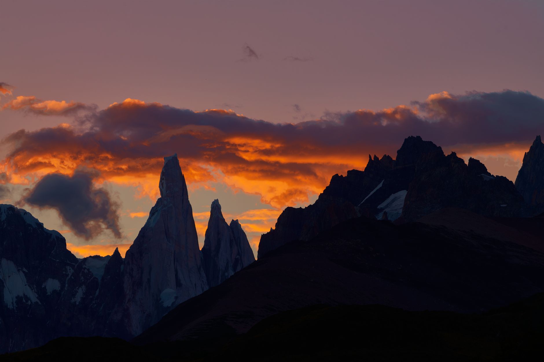 Towering granite peak emerging from stormy mountain clouds